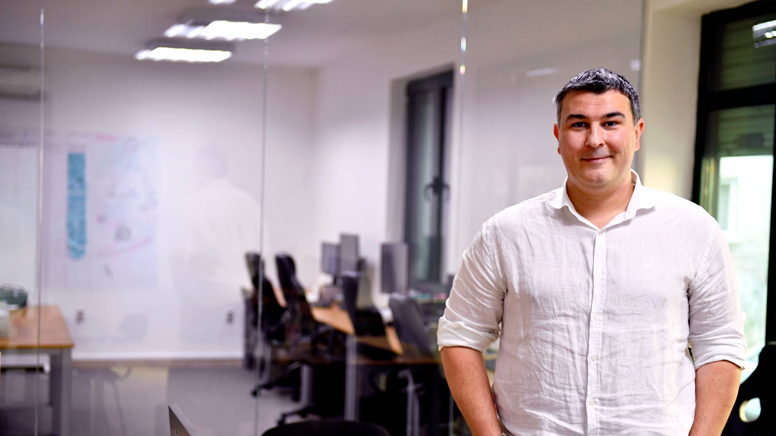 Nenad Novovic owner of Amplitudo standing in his offfice.